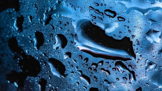 Water droplets on a smooth surface.
